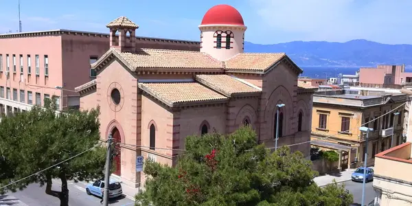 The red dome of the Church of the Ottimati glowing in the sun above Reggio Calabria’s historic center.