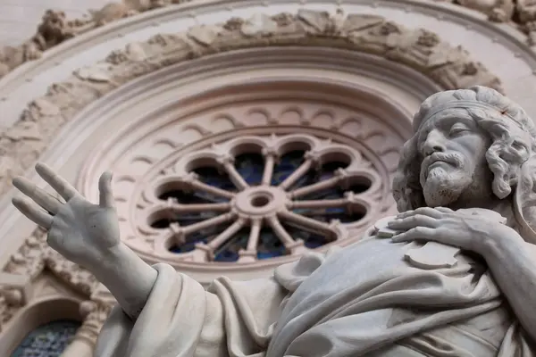 The neo-Romanesque facade of Reggio Calabria Cathedral with statues of Saint Paul and Saint Stephen.