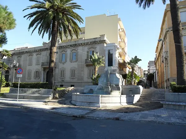 View of La Luminosa fountain in Reggio Calabria with its central column, cascading water, and mosaic base