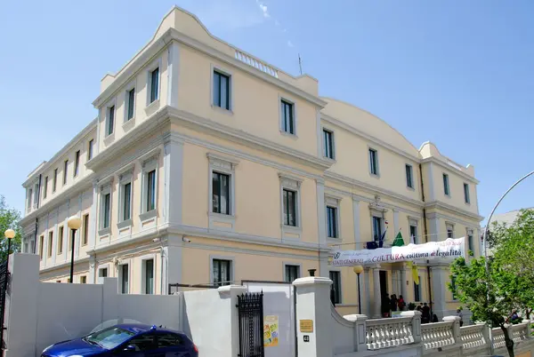 Exhibition hall of Palazzo Crupi with paintings, ancient books, and sacred art objects on display.