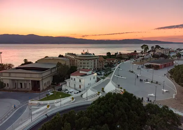 View of Reghium Waterfront promenade in Reggio Calabria with sea-facing paths, modern design, and lush greenery.