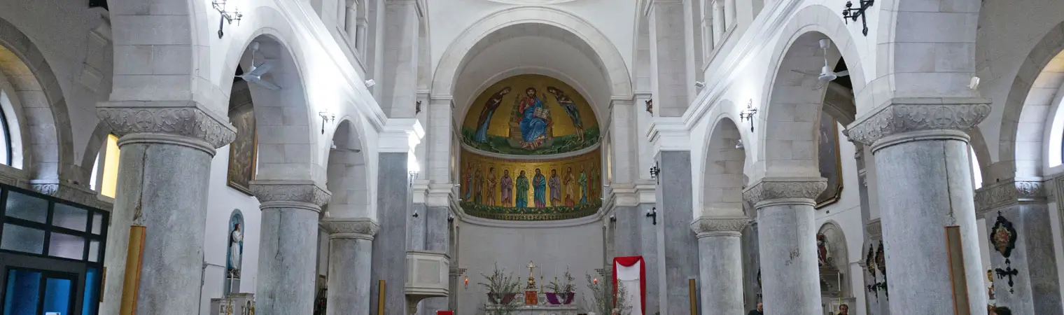 The domes and interior of the Church of Saints Philip and James in Reggio Calabria, featuring the Madonna della Cintura.