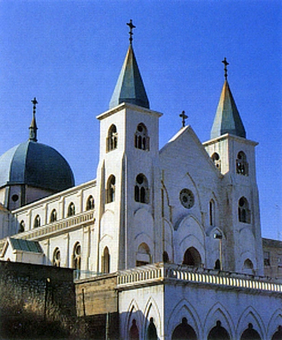 The Sanctuary of Saint Anthony of Padua in Reggio Calabria, with its Gothic towers and central rose window shining over the city.